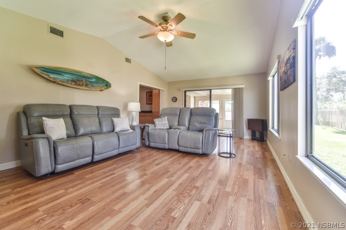 700 Green Road New Smyrna Beach, FL 32168 - Photo 11 of 37 a living room with furniture and a large window