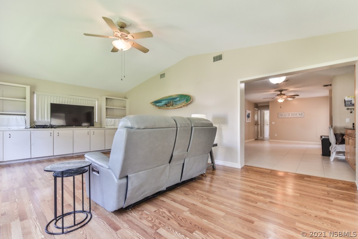 700 Green Road New Smyrna Beach, FL 32168 - Photo 13 of 37 a living room with furniture and a flat screen tv