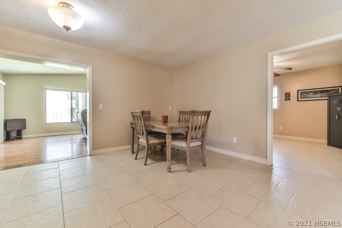 700 Green Road New Smyrna Beach, FL 32168 - Photo 18 of 37 a view of a dining room with furniture and a chandelier