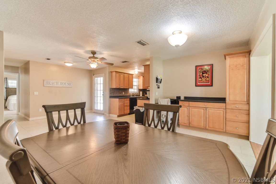 700 Green Road New Smyrna Beach, FL 32168 - Photo 19 of 37 a view of kitchen with dining room and wooden floor