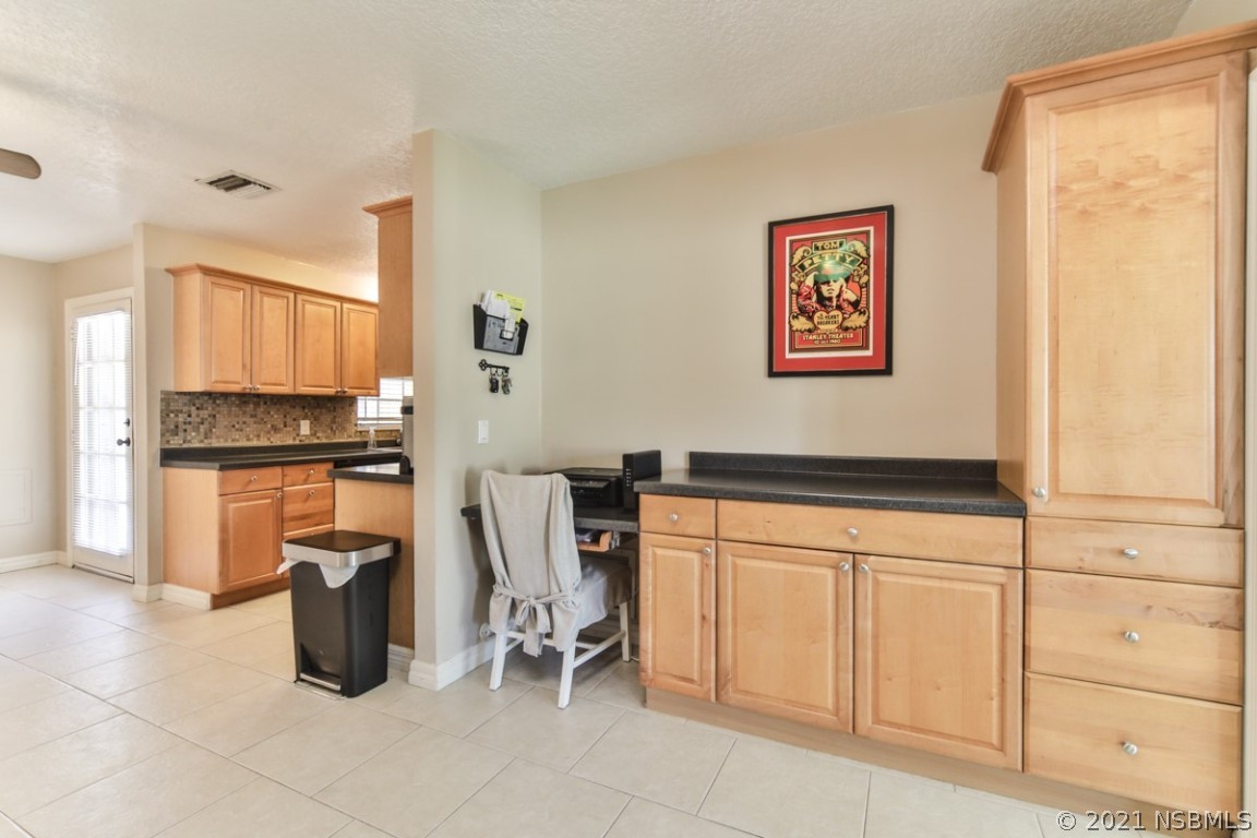 700 Green Road New Smyrna Beach, FL 32168 - Photo 20 of 37 a kitchen with stainless steel appliances a refrigerator and cabinets