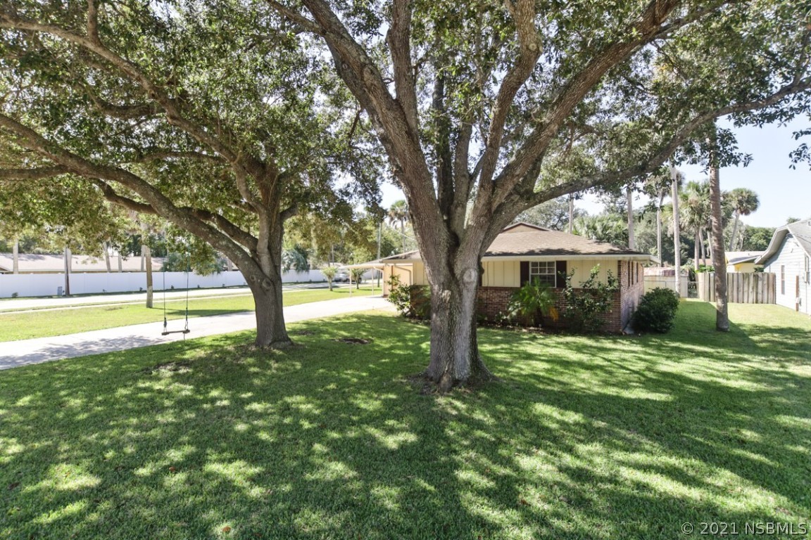 700 Green Road New Smyrna Beach, FL 32168 - Photo 2 of 37 a view of a house with a yard