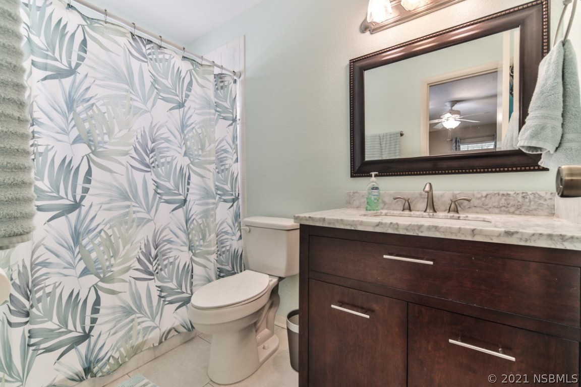 700 Green Road New Smyrna Beach, FL 32168 - Photo 23 of 37 a bathroom with a toilet sink and mirror