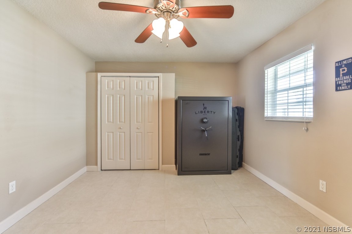 700 Green Road New Smyrna Beach, FL 32168 - Photo 25 of 37 an empty room with windows and fan