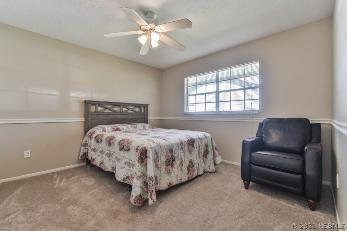700 Green Road New Smyrna Beach, FL 32168 - Photo 29 of 37 a bedroom with a large bed and a couch