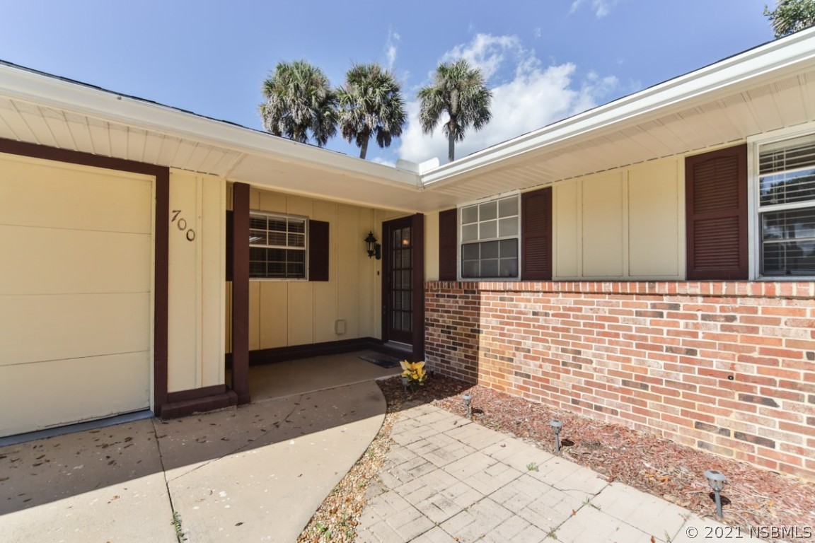 700 Green Road New Smyrna Beach, FL 32168 - Photo 6 of 37 a view of a porch with a table and chairs