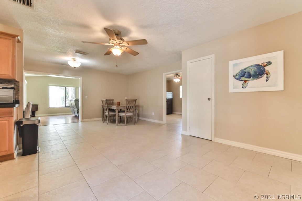700 Green Road New Smyrna Beach, FL 32168 - Photo 7 of 37 a view of a livingroom with furniture and a ceiling fan