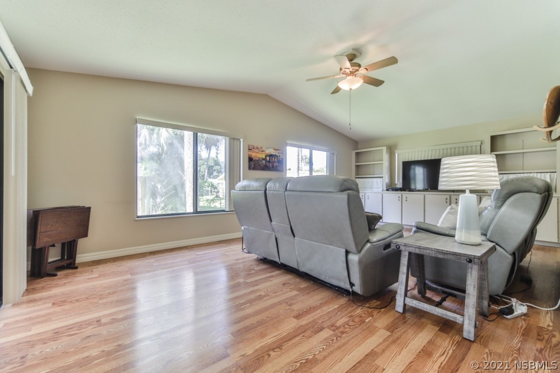 700 Green Road New Smyrna Beach, FL 32168 - Photo 9 of 37 a living room with furniture and a wooden floor