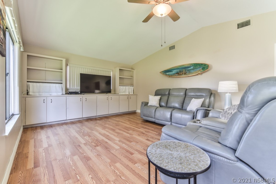 700 Green Road New Smyrna Beach, FL 32168 - Photo 10 of 37 a living room with furniture and a flat screen tv