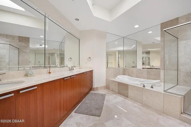 a bathroom with a sink a mirror and a shower