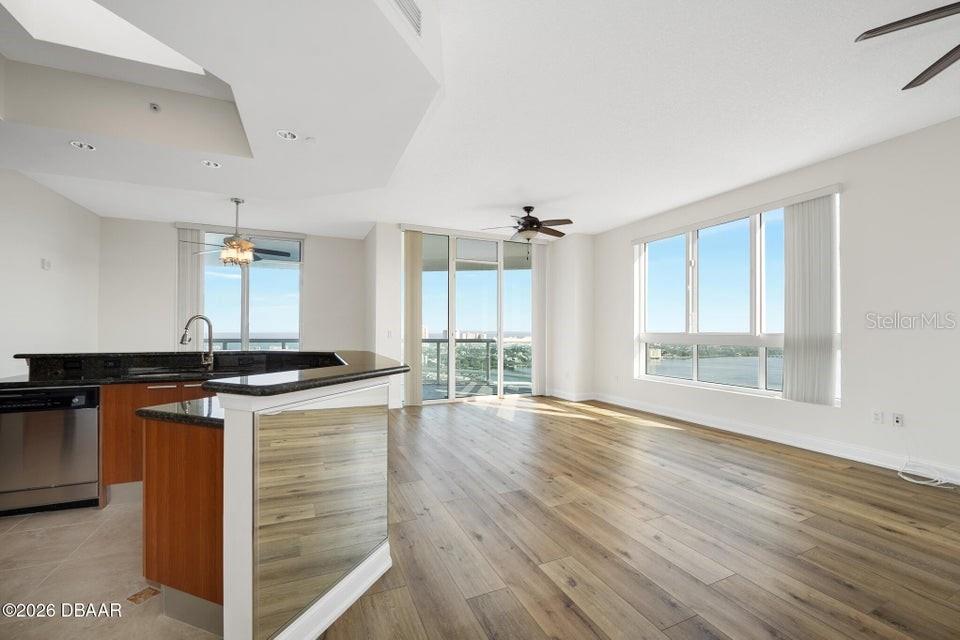 231 Riverside Drive, Unit 26011 Daytona Beach, FL 32117 - Photo 12 of 56 a kitchen with granite countertop a stove and a sink