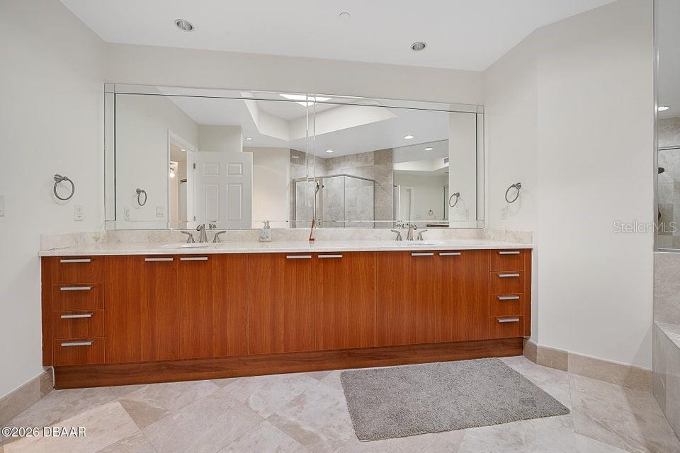 231 Riverside Drive, Unit 26011 Daytona Beach, FL 32117 - Photo 13 of 56 a bathroom with a sink vanity and mirror