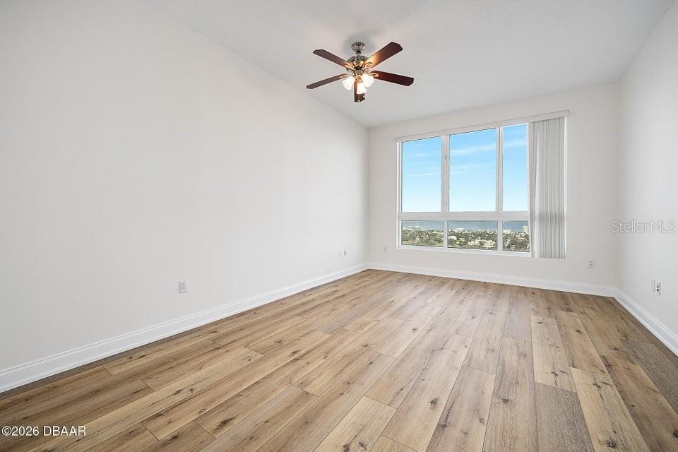 231 Riverside Drive, Unit 26011 Daytona Beach, FL 32117 - Photo 17 of 56 an empty room with wooden floor and windows