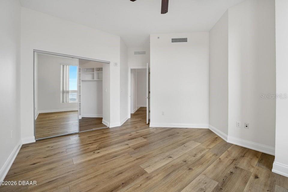 231 Riverside Drive, Unit 26011 Daytona Beach, FL 32117 - Photo 17 of 56 a view of an empty room with wooden floor