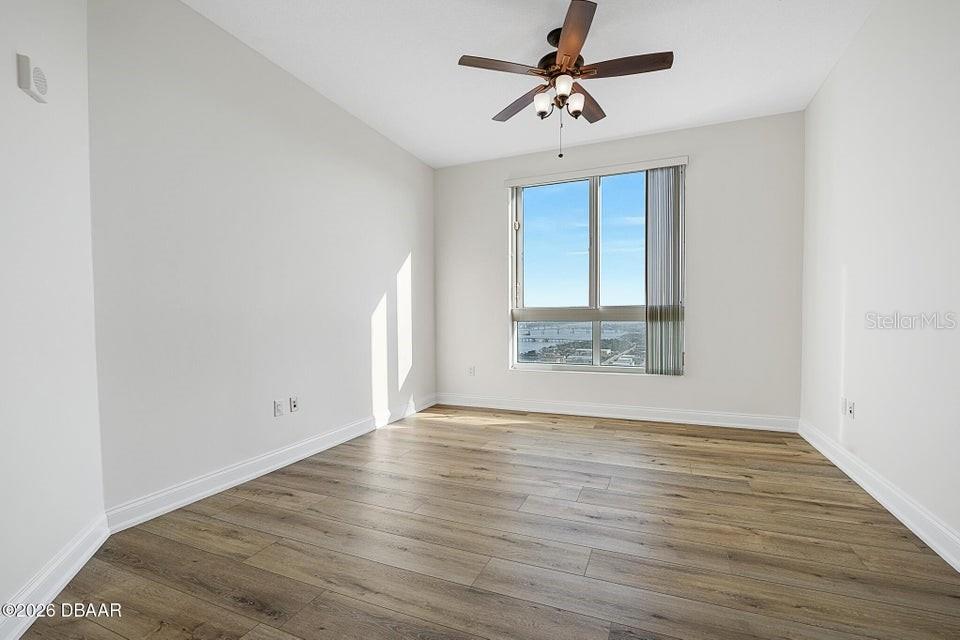 231 Riverside Drive, Unit 26011 Daytona Beach, FL 32117 - Photo 26 of 56 wooden floor in an empty room with a window
