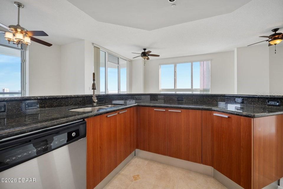 231 Riverside Drive, Unit 26011 Daytona Beach, FL 32117 - Photo 29 of 56 a kitchen with stainless steel appliances a sink dishwasher a stove and a refrigerator
