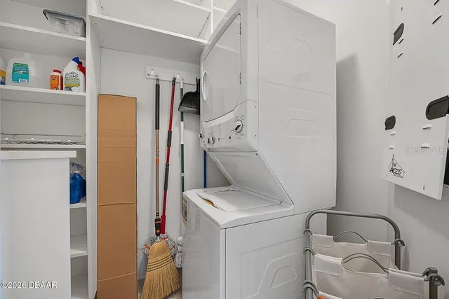 a view of roof deck with couches under an umbrella