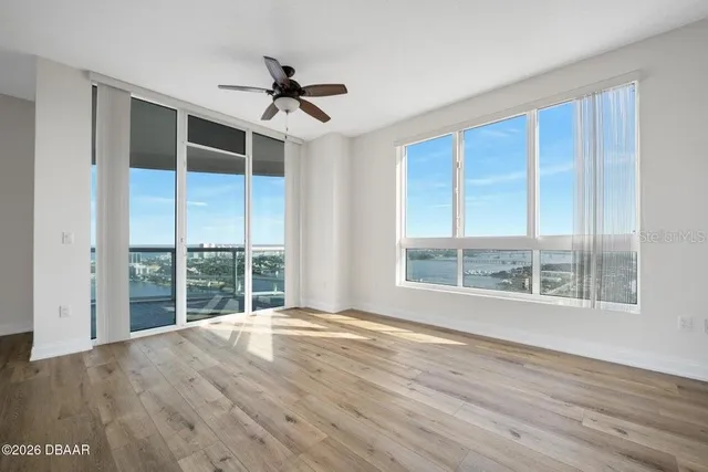 a view of a kitchen with wooden floor and a window