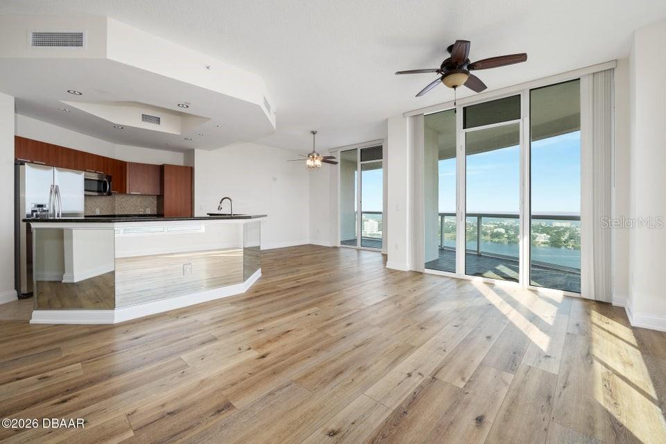231 Riverside Drive, Unit 26011 Daytona Beach, FL 32117 - Photo 7 of 56 a view of a kitchen with wooden floor and a window