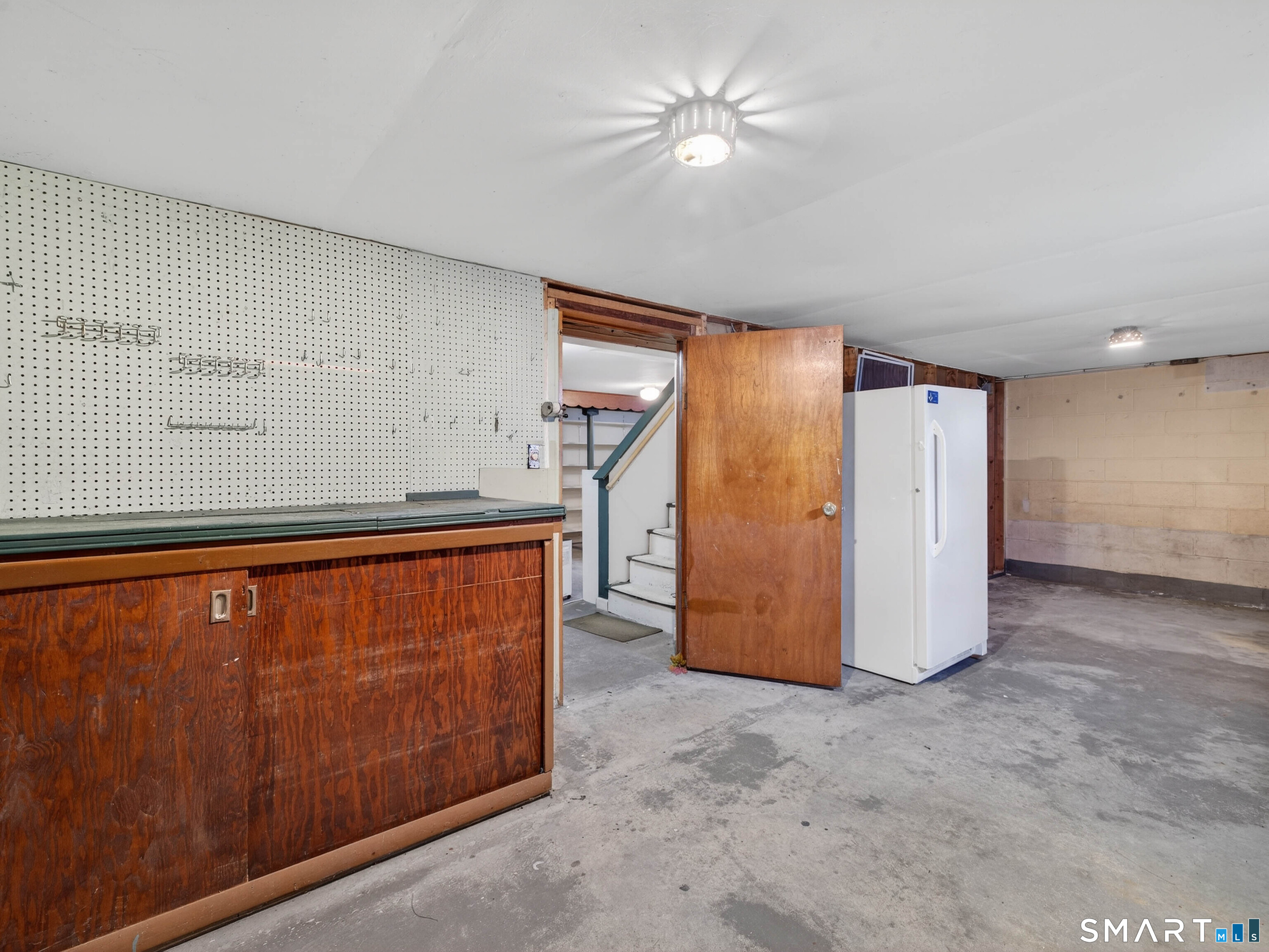 15 Buell Court Clinton, CT 06413 - Photo 24 of 29 Work area in basement. Other half of