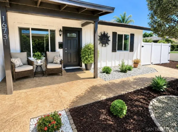 a view of a house with backyard and sitting area