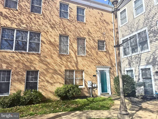 a view of a brick building next to a yard