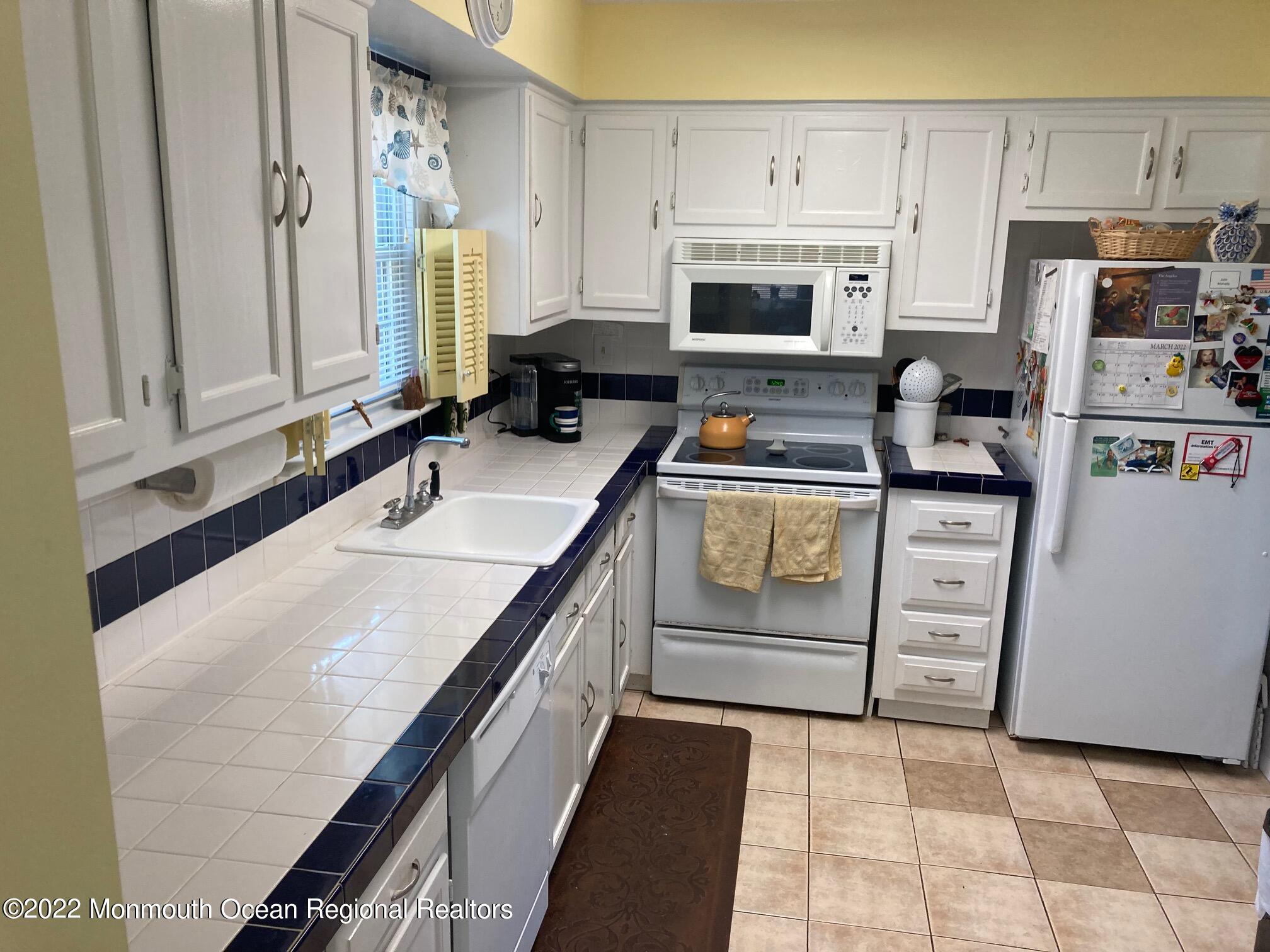 8 Masters Road Brick, NJ 08724 - Photo 2 of 11 a kitchen with stainless steel appliances granite countertop a stove a sink and a refrigerator