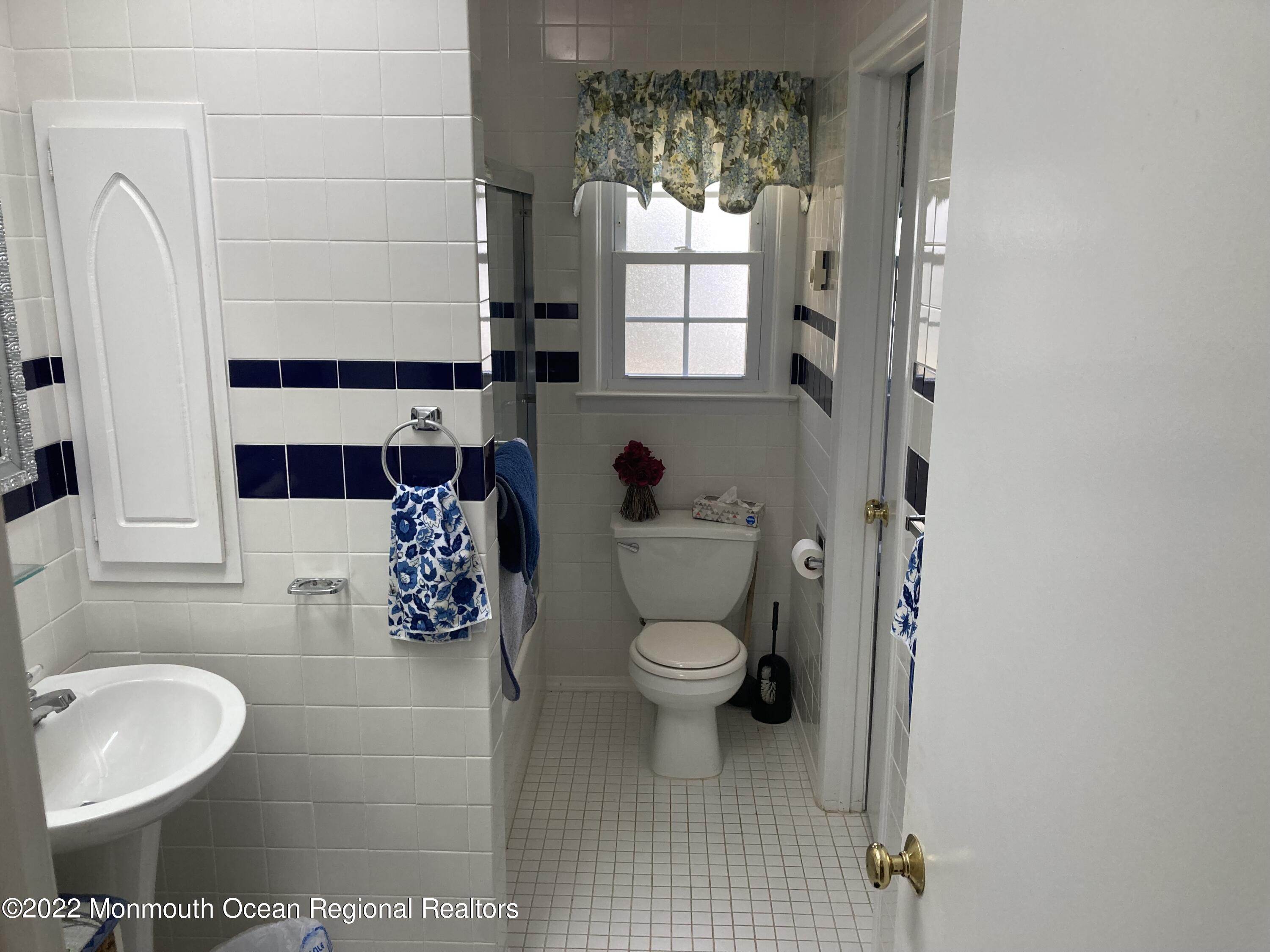 8 Masters Road Brick, NJ 08724 - Photo 7 of 11 a bathroom with a toilet sink and mirror