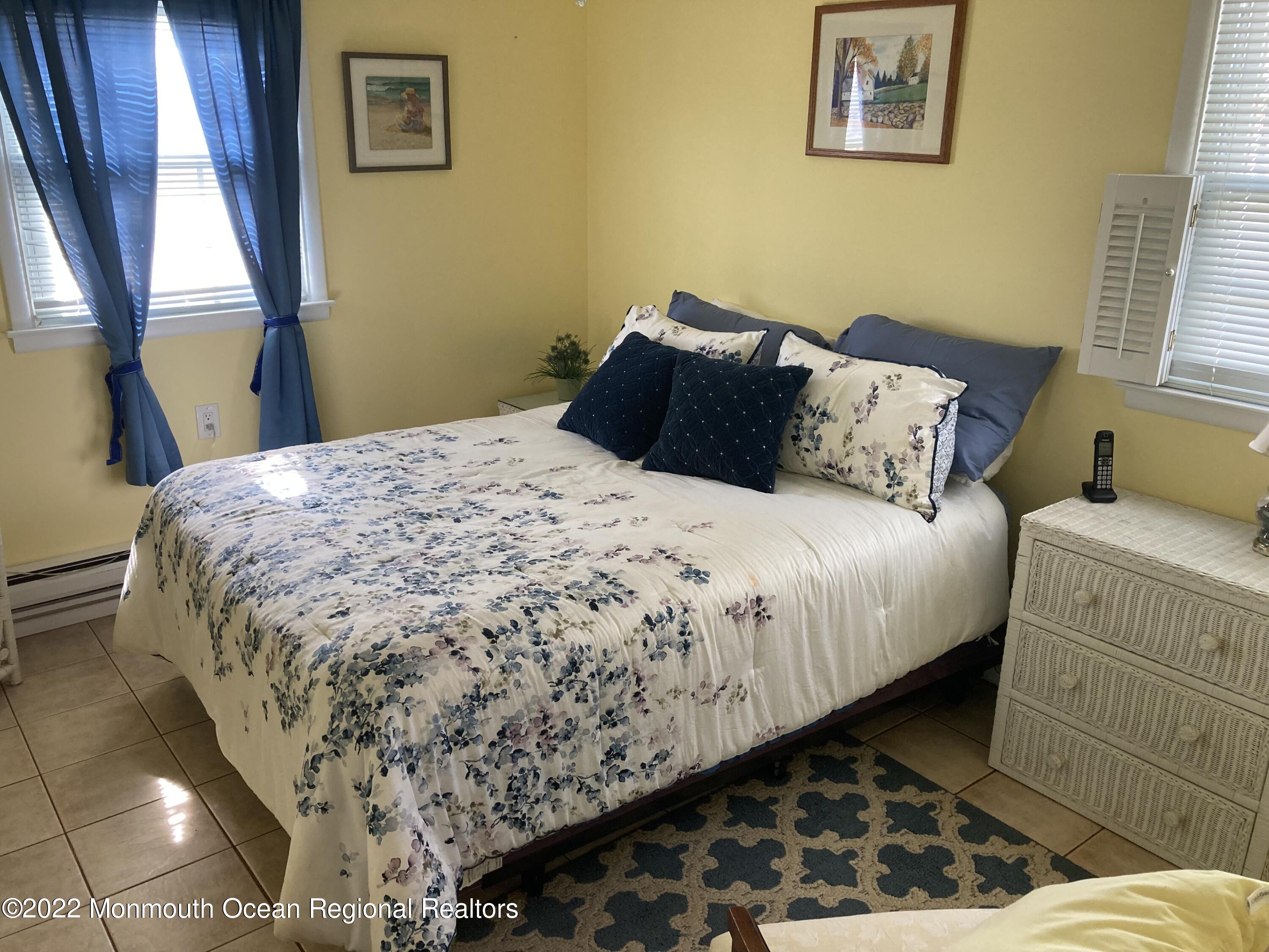 8 Masters Road Brick, NJ 08724 - Photo 10 of 11 a bed sitting in a bedroom next to a window