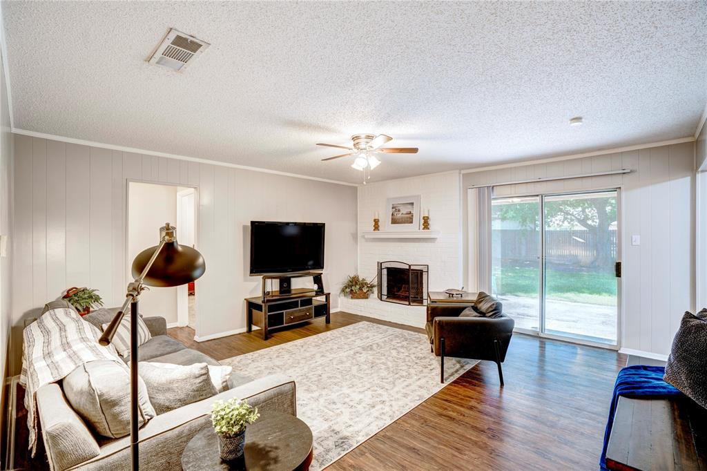 6028 Ridgecrest Drive Watauga, TX 76148 - Photo 5 of 40 a living room with furniture a fireplace and a flat screen tv