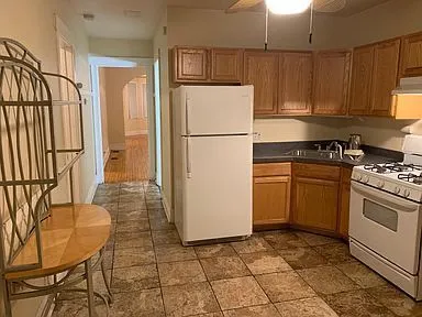 a kitchen with a stove a refrigerator and a cabinets
