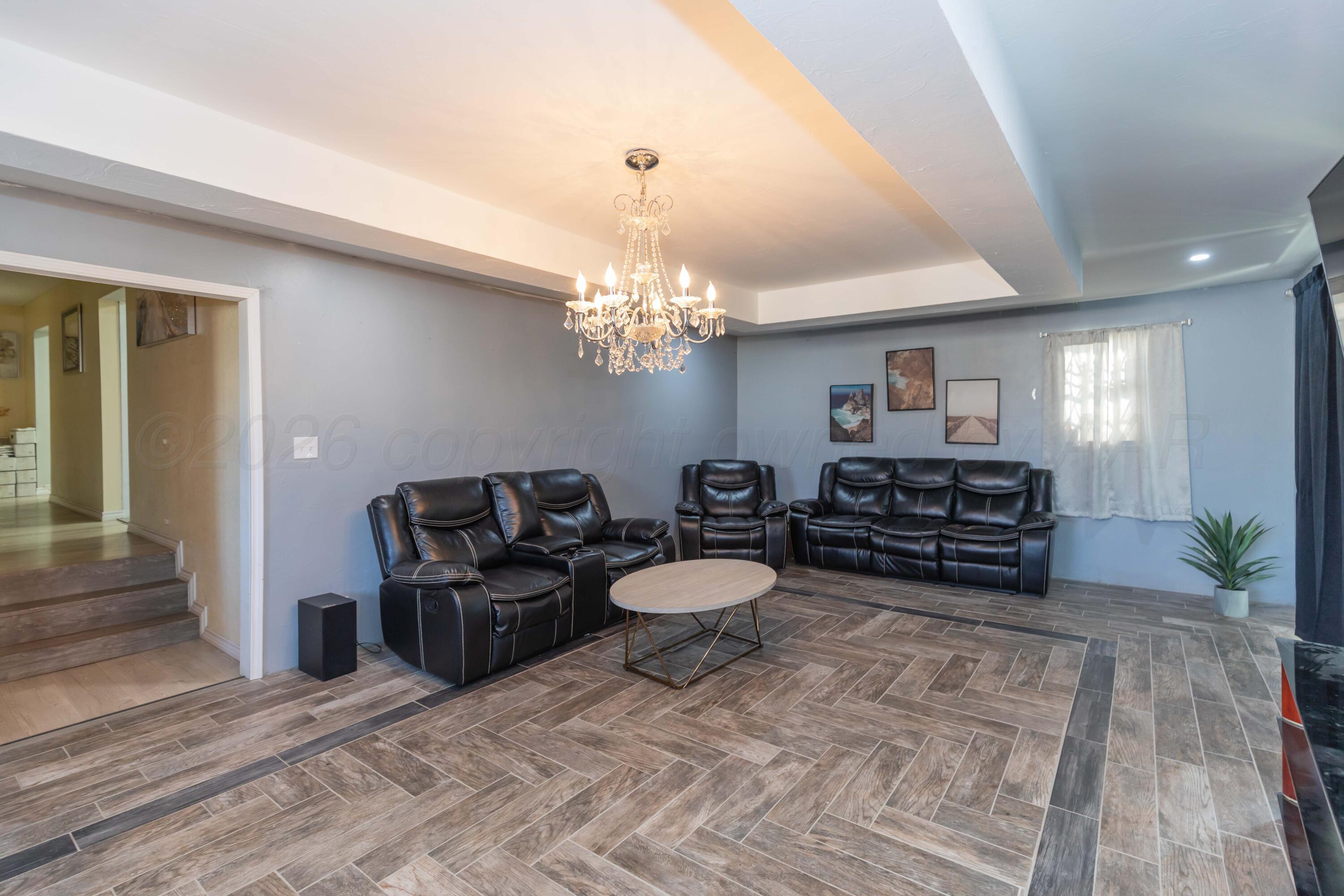 905 North Travis Street Amarillo, TX 79107 - Photo 11 of 42 a living room with furniture and a chandelier