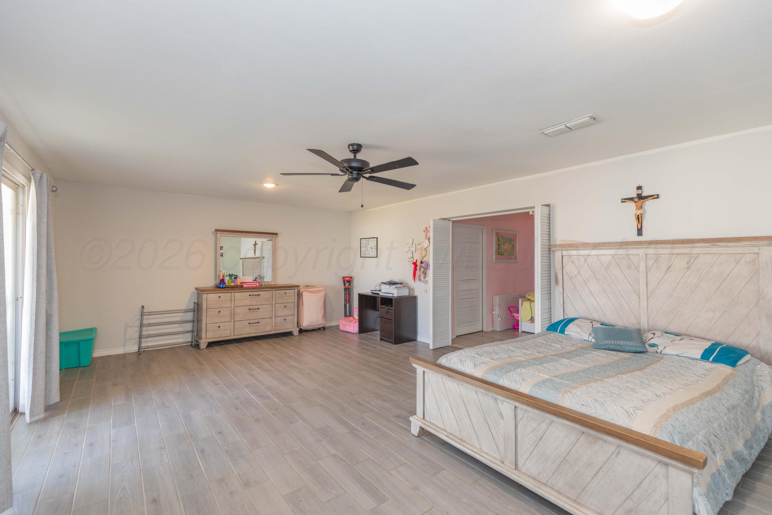 905 North Travis Street Amarillo, TX 79107 - Photo 18 of 42 a bedroom with a bed and a chandelier