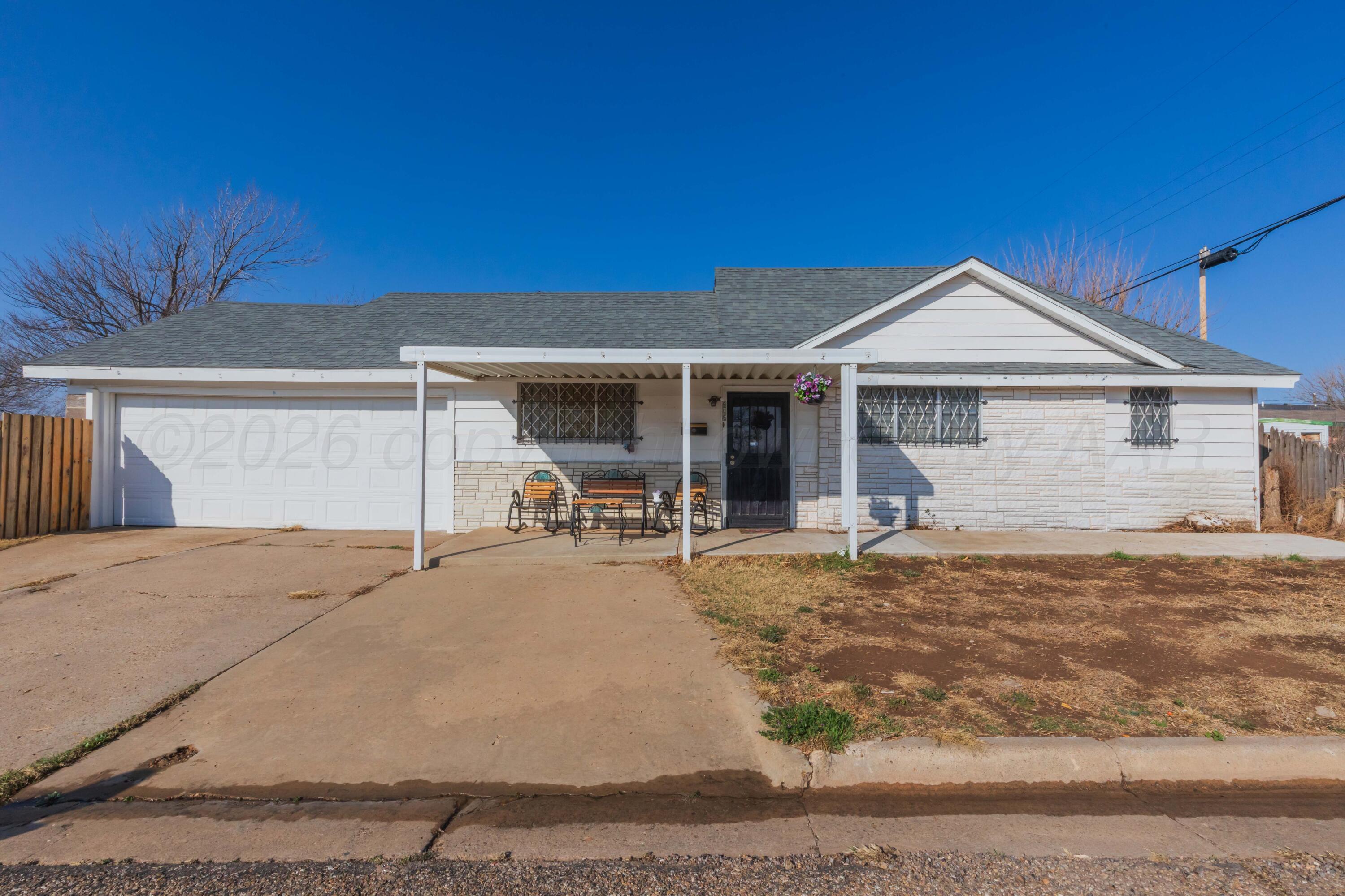 905 North Travis Street Amarillo, TX 79107 - Photo 2 of 42 a backyard of a house with table and chairs