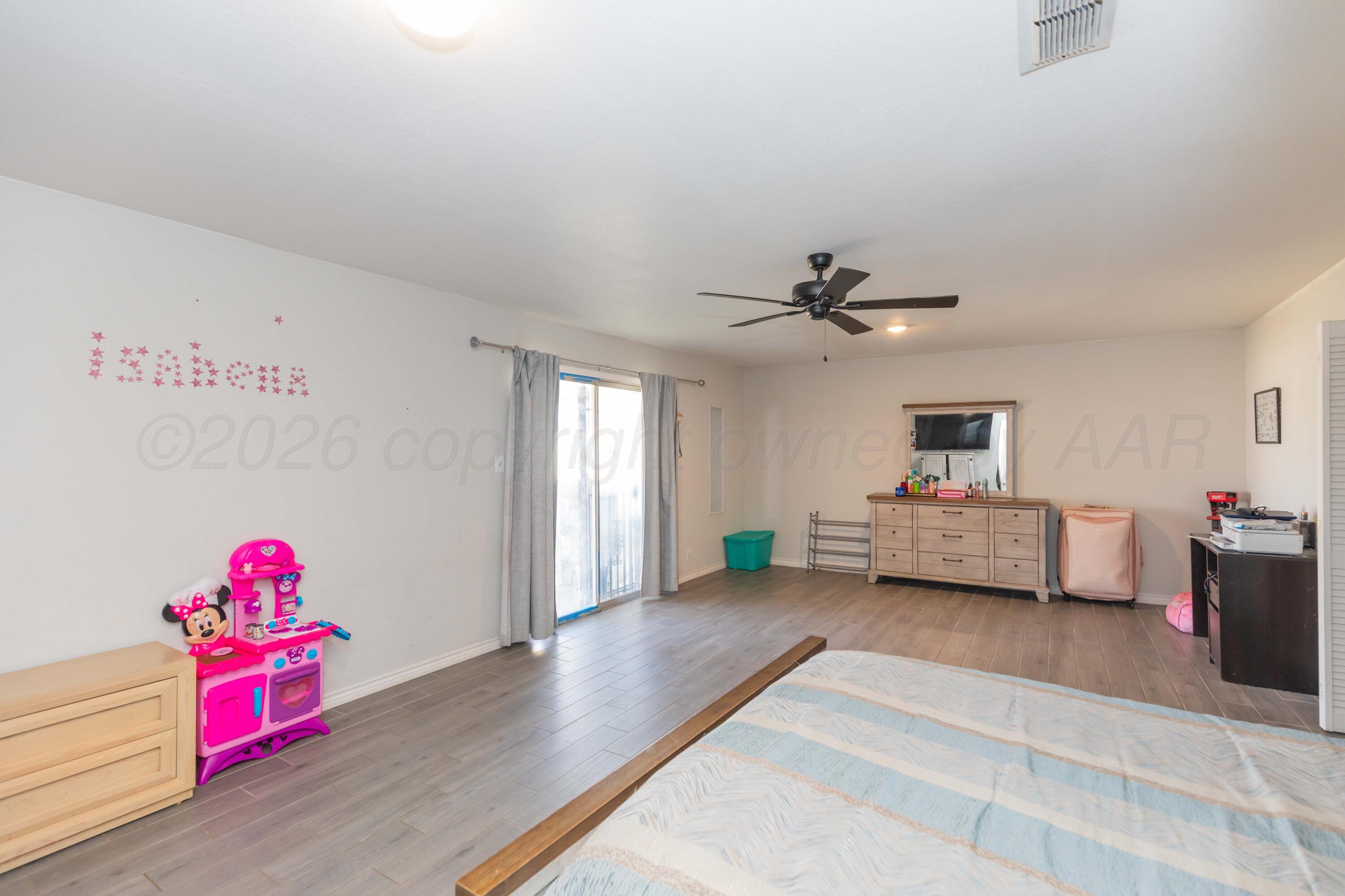 905 North Travis Street Amarillo, TX 79107 - Photo 21 of 42 a bedroom with furniture and window