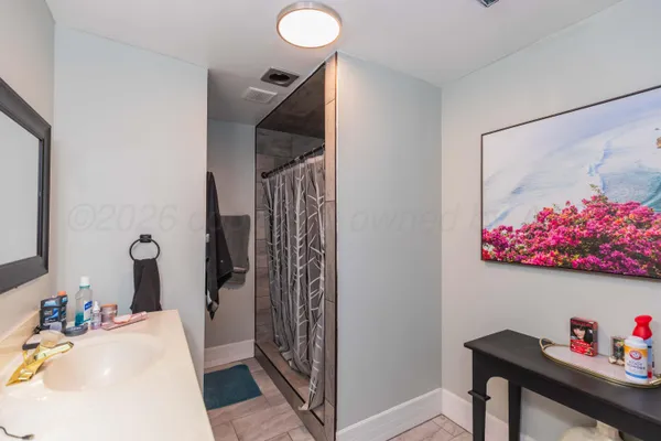 a bedroom with furniture and a flat screen tv