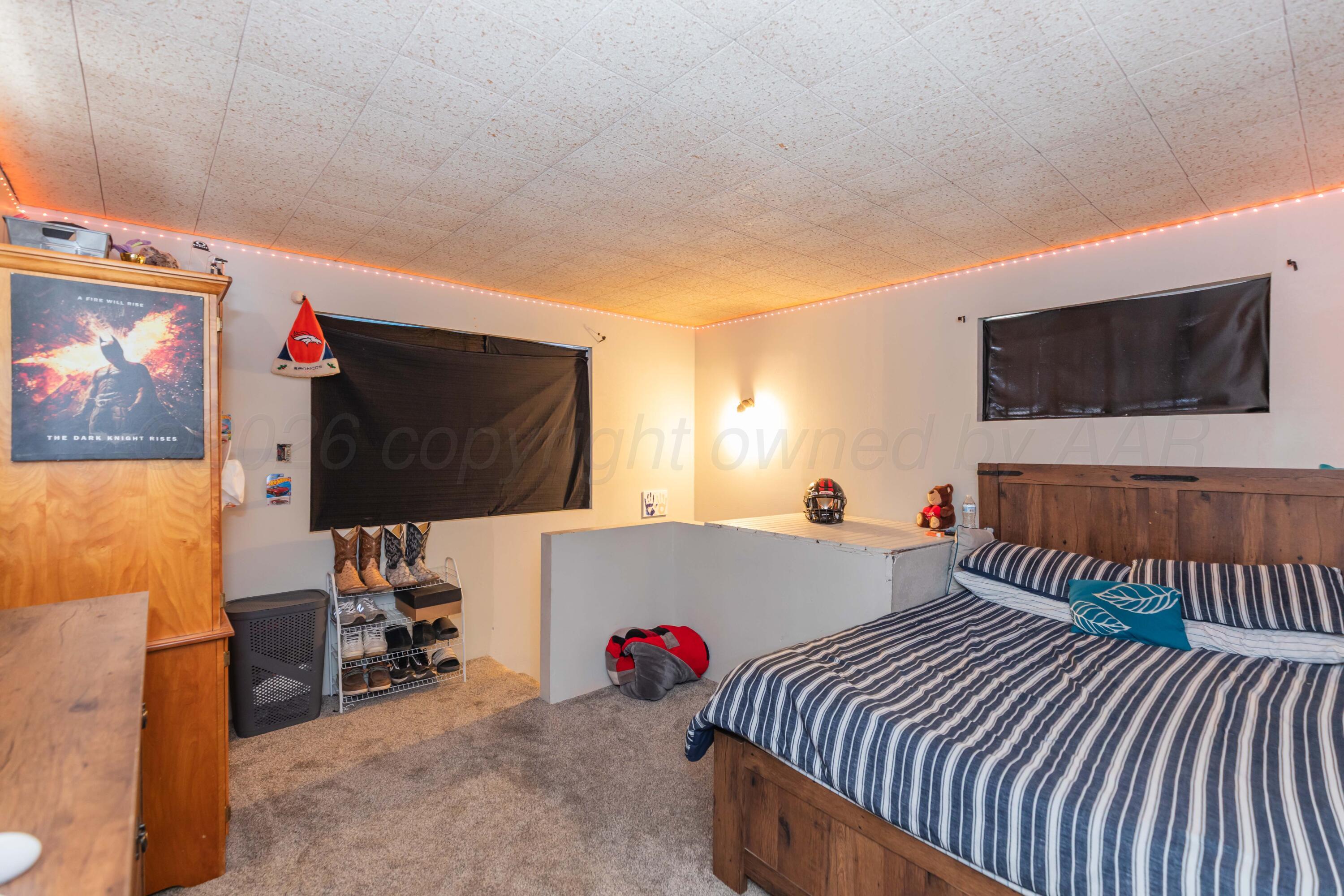 905 North Travis Street Amarillo, TX 79107 - Photo 24 of 42 a bedroom with furniture and a flat screen tv