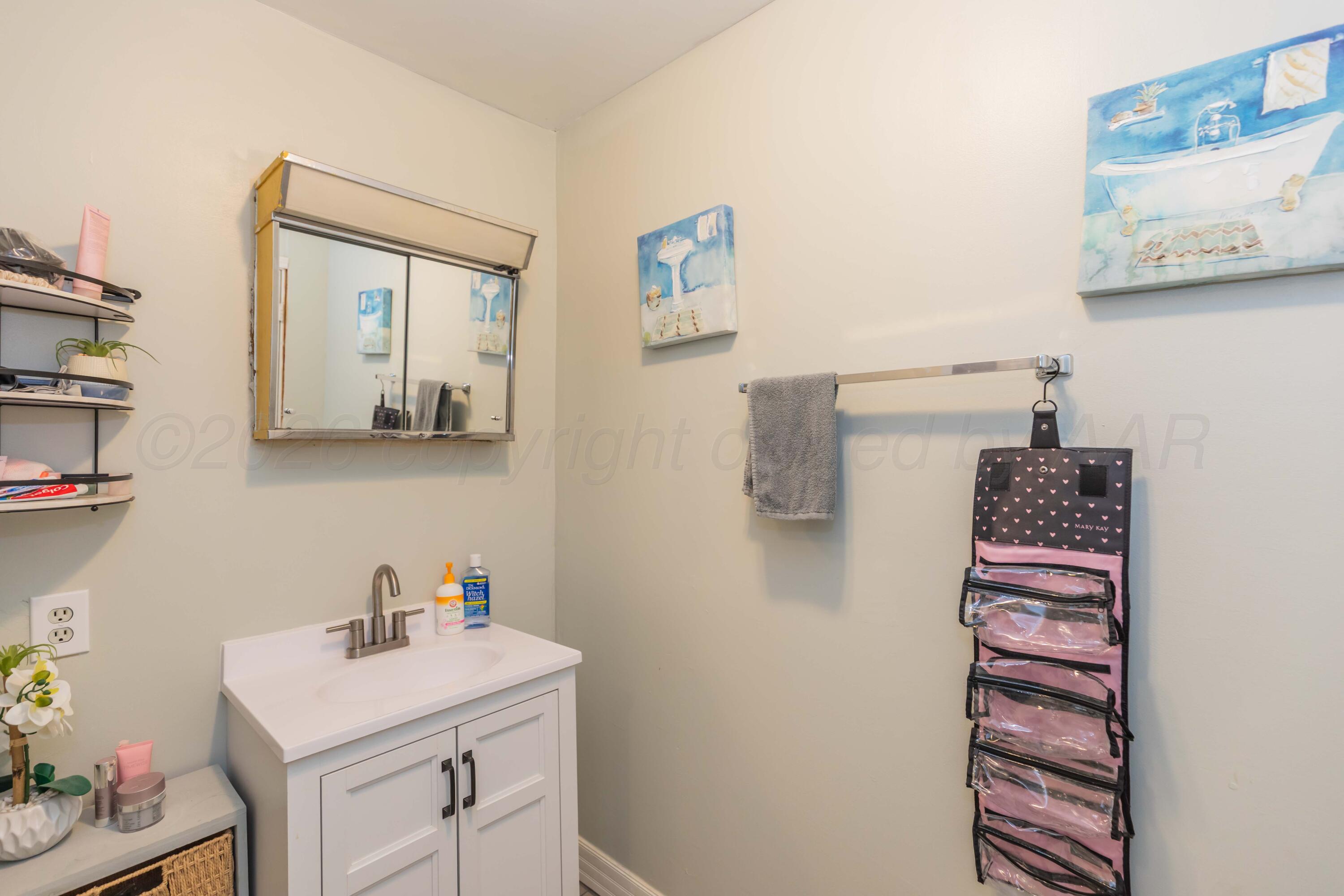 905 North Travis Street Amarillo, TX 79107 - Photo 27 of 42 a bathroom with a sink and a mirror