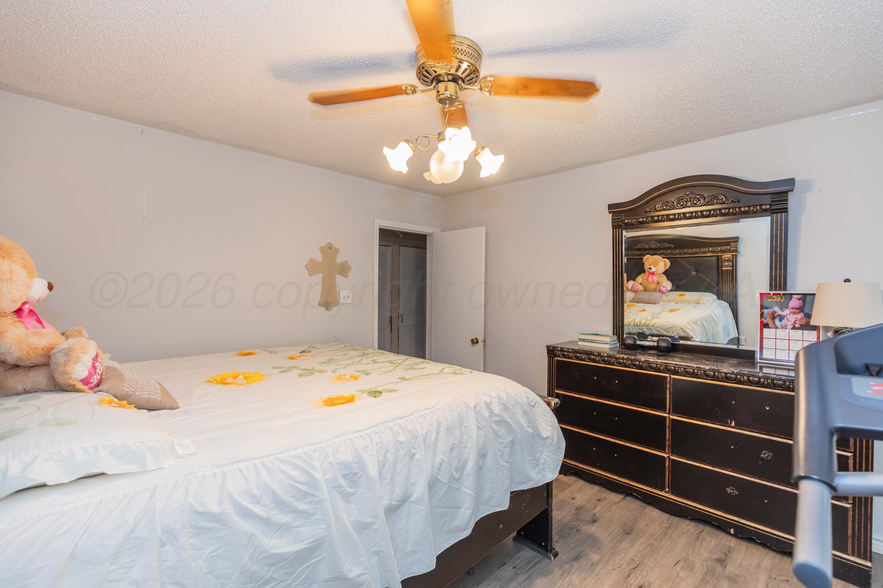 905 North Travis Street Amarillo, TX 79107 - Photo 29 of 42 a bedroom with a bed and a chandelier