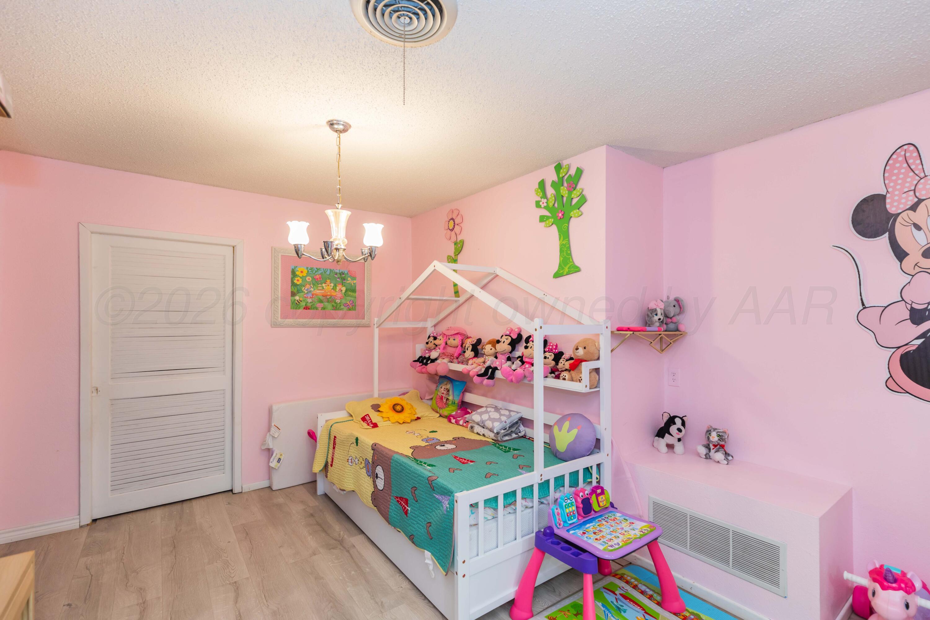 905 North Travis Street Amarillo, TX 79107 - Photo 34 of 42 a children room with toys and a chandelier