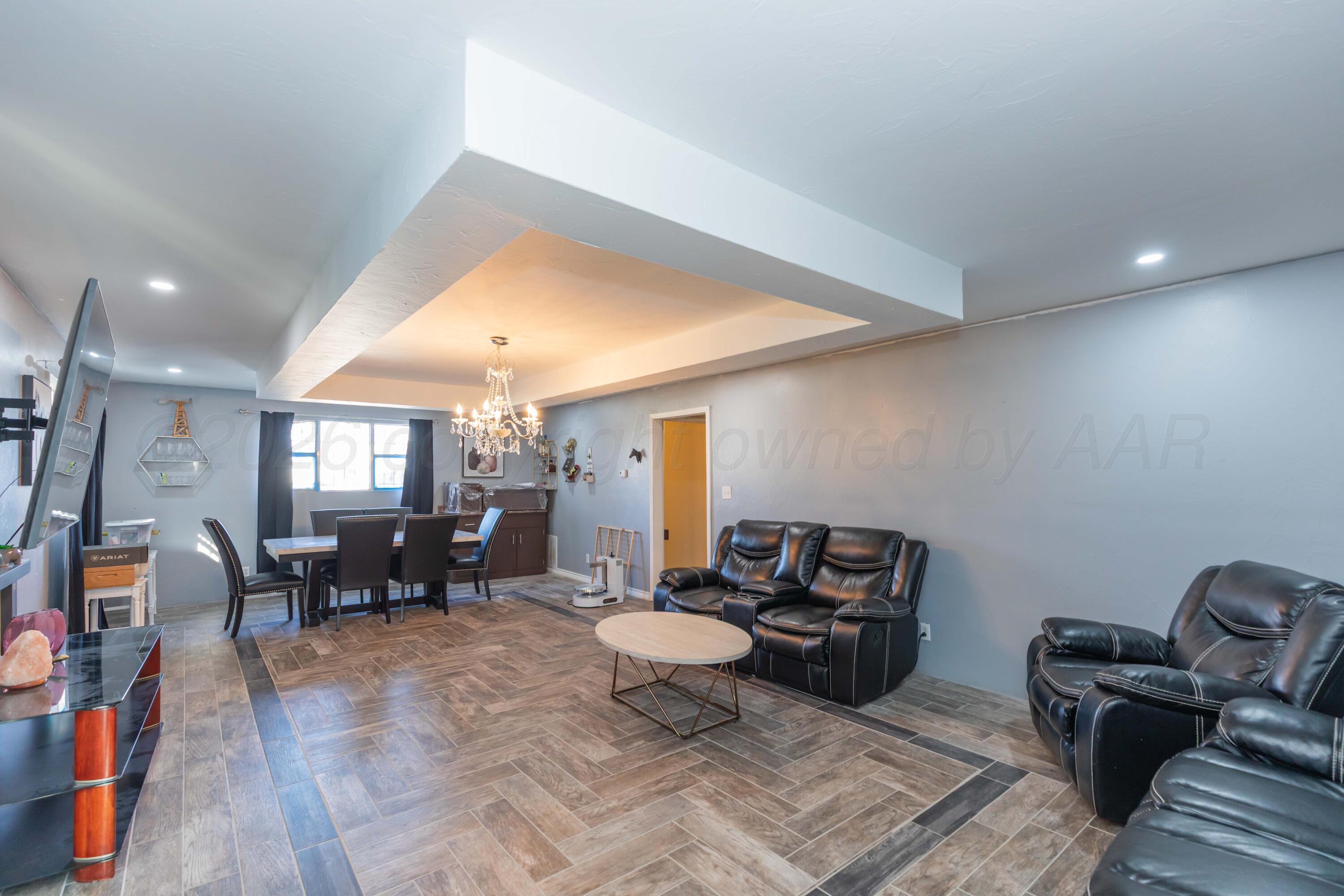 905 North Travis Street Amarillo, TX 79107 - Photo 8 of 42 a living room with furniture and a chandelier