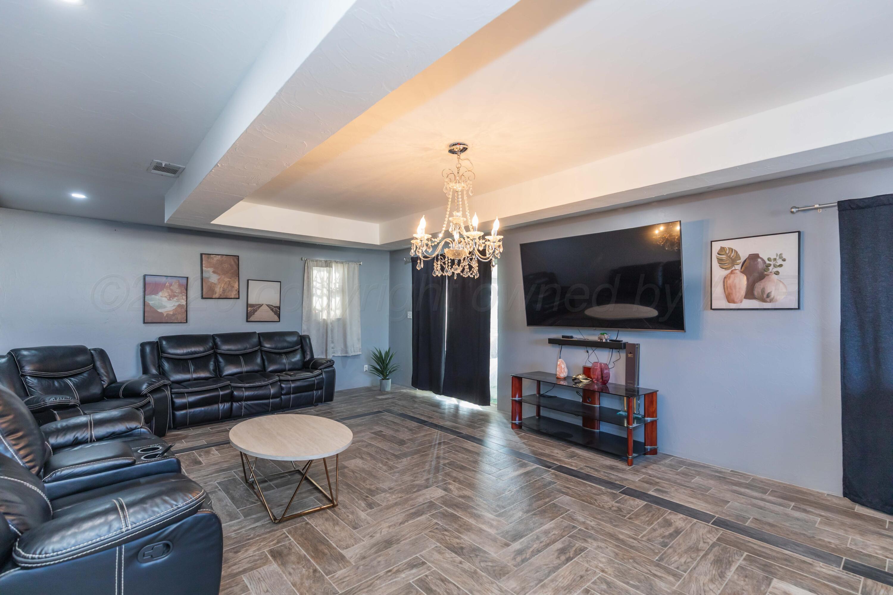 905 North Travis Street Amarillo, TX 79107 - Photo 9 of 42 a living room with furniture and a flat screen tv