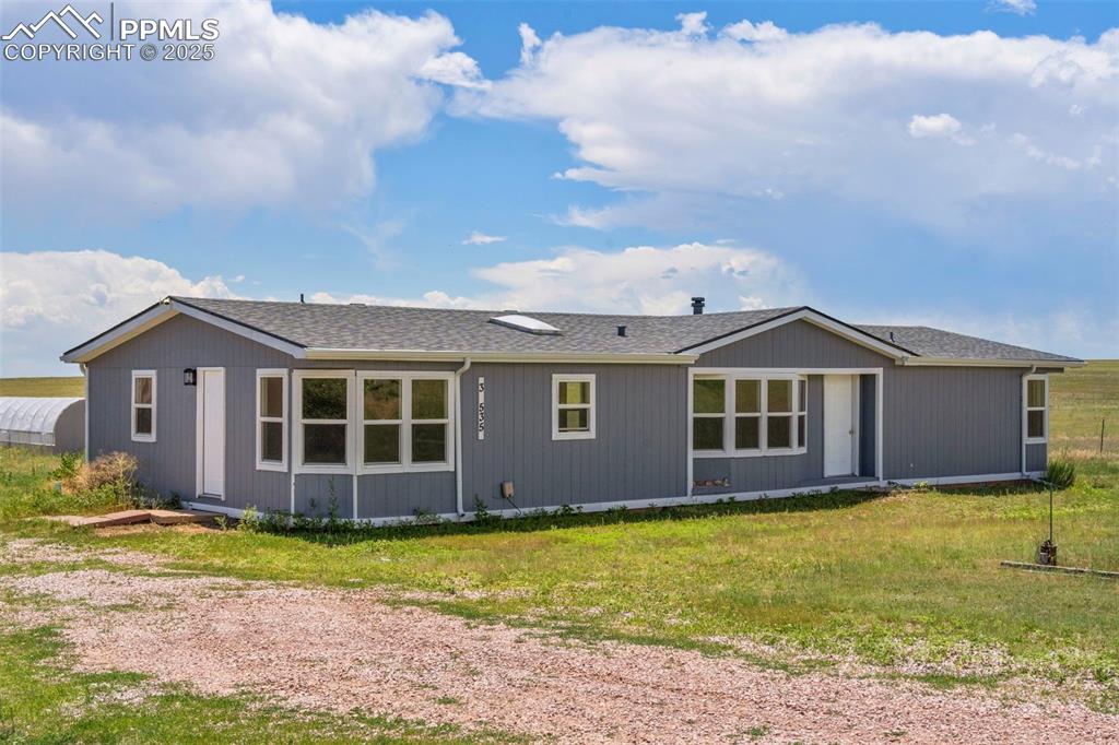34535 Big Springs Road Yoder, CO 80864 - Photo 2 of 34 a front view of a house with garden