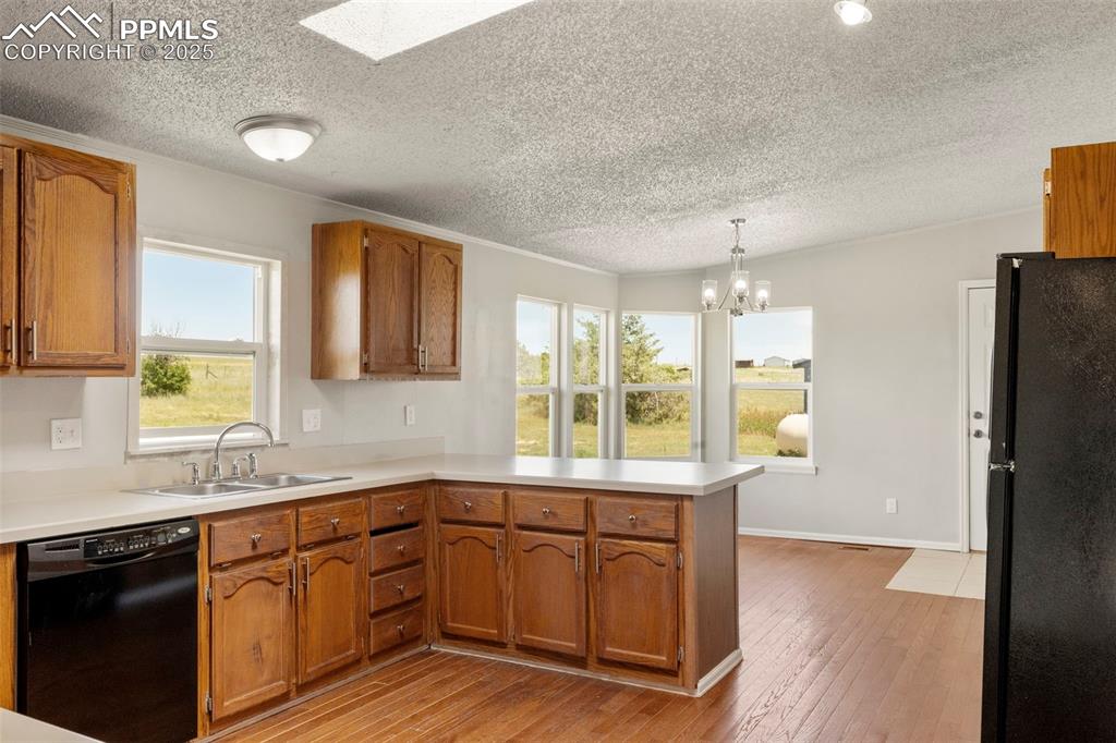 34535 Big Springs Road Yoder, CO 80864 - Photo 9 of 34 a kitchen with stainless steel appliances granite countertop a sink cabinets and wooden floor