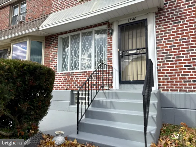 a view of front door of house with stairs