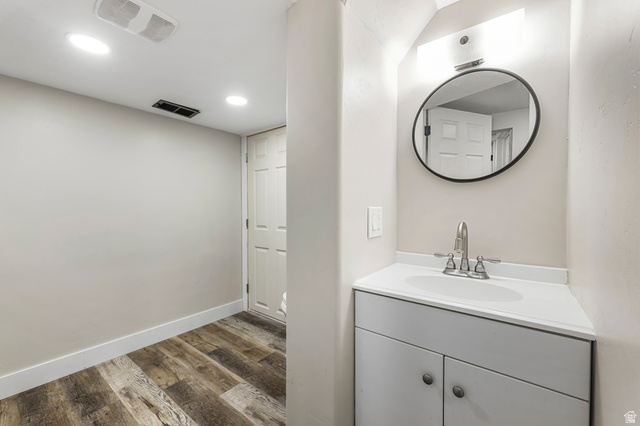 523 South Main Street Payson, UT 84651 - Photo 29 of 41 Vanity area featuring a circular mirror, brushed nickel faucet, and a white countertop