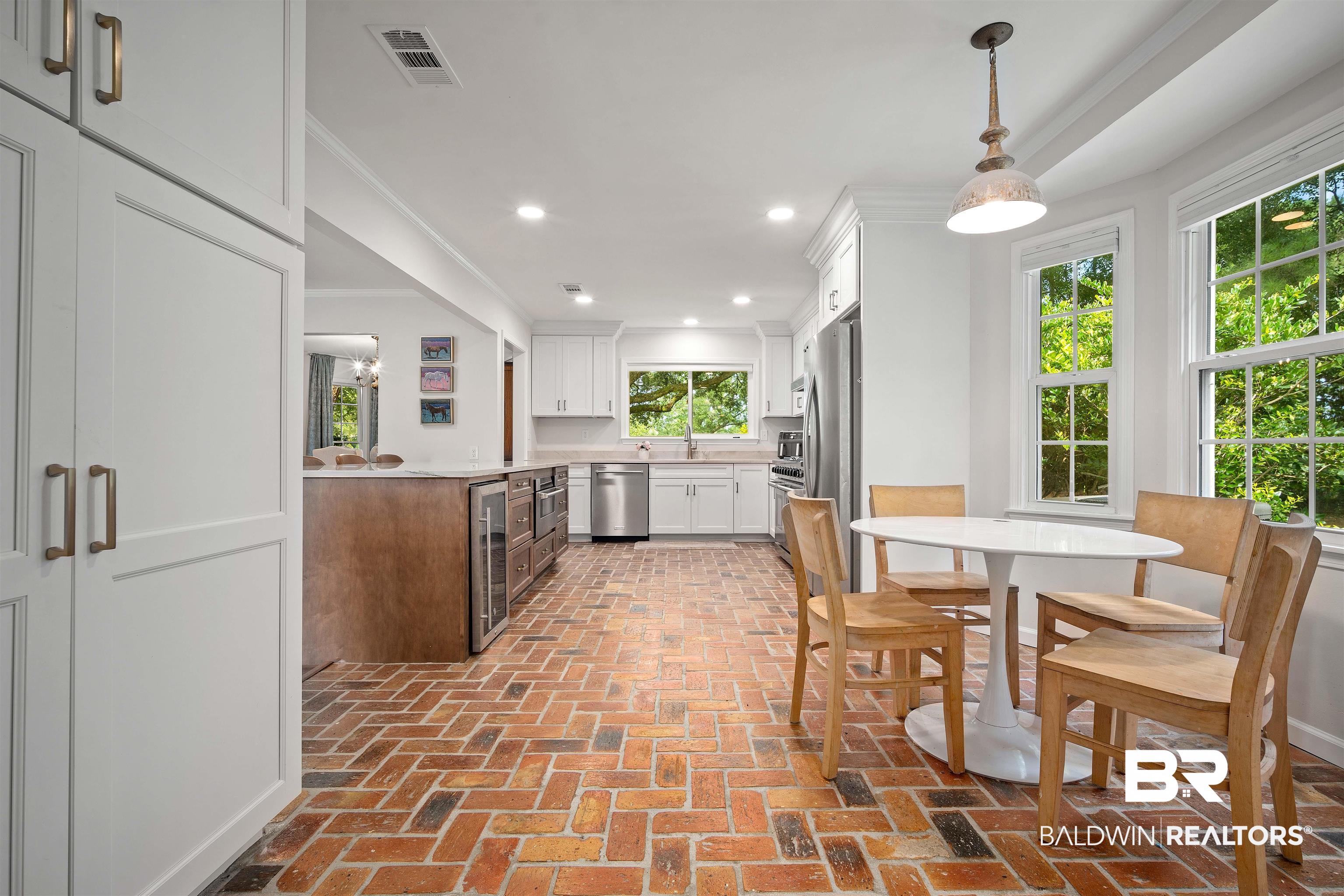700 Eliza Jordan Road North Mobile, AL 36608 - Photo 15 of 44 Kitchen with white cabinetry, light countertops, brick floors, recessed lighting, and stainless steel appliances