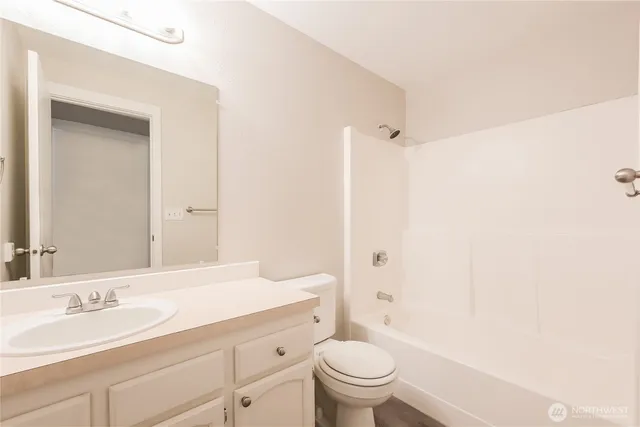 a bathroom with a sink a toilet and a large mirror