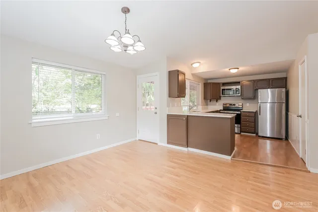a view of a kitchen with a sink a refrigerator and window