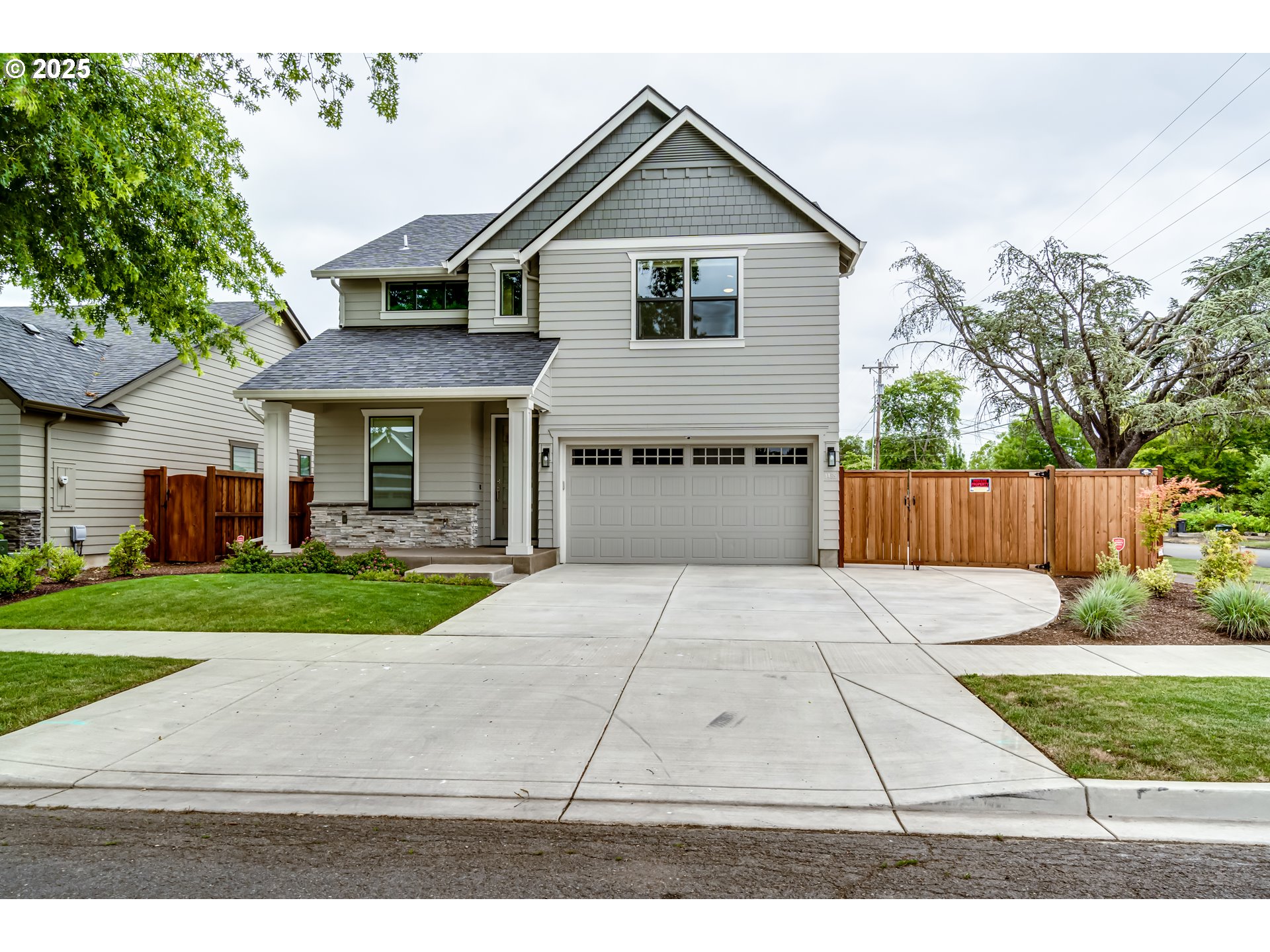 a front view of a house with a yard and a garage